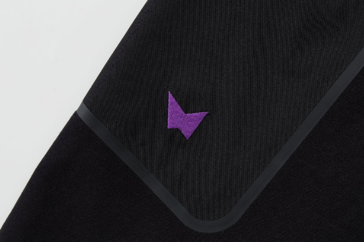Black towel with a purple logo on a white background